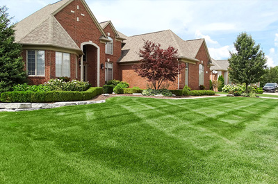 A nice brick home with freshly-mowed grass
